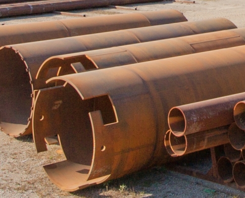 view of various sized pipes in yard