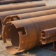 view of various sized pipes in yard