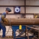 Worker operating a piling pipe machine