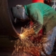 worker using cutting welder on large pipe