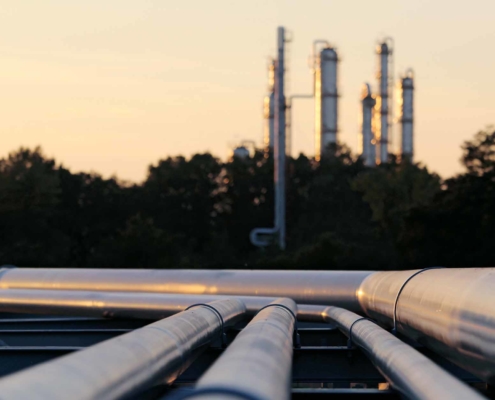 Close up view of refinery pipe at dusk