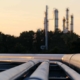 Close up view of refinery pipe at dusk